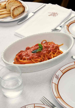 a white dish that contains organic cipriani spaghetti and tomato sauce